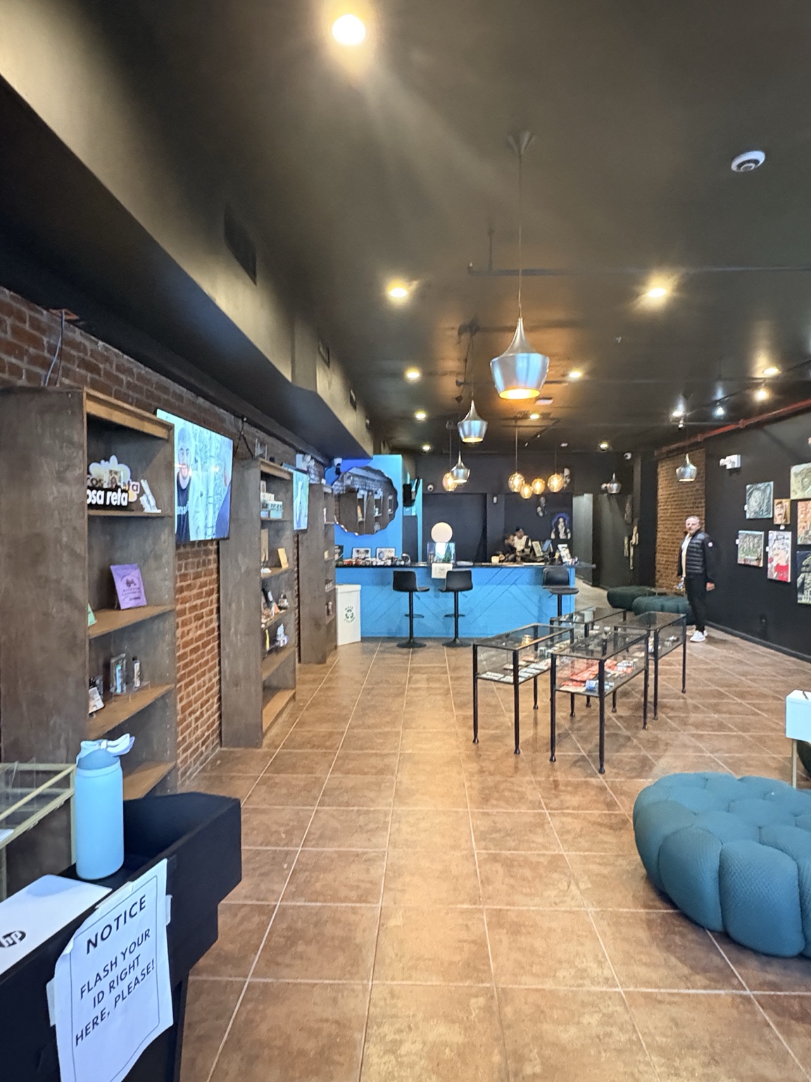 Current state of dispensary — sparse shelves, taped notice, no signage